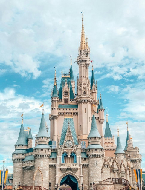 white and blue castle under blue sky and white clouds during daytime